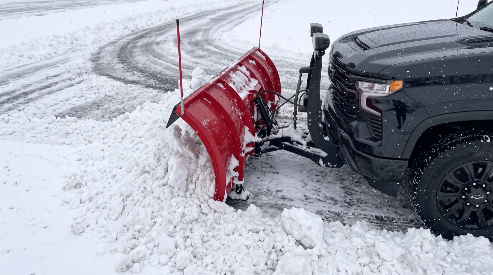 Truck plowing a snow-covered driveway