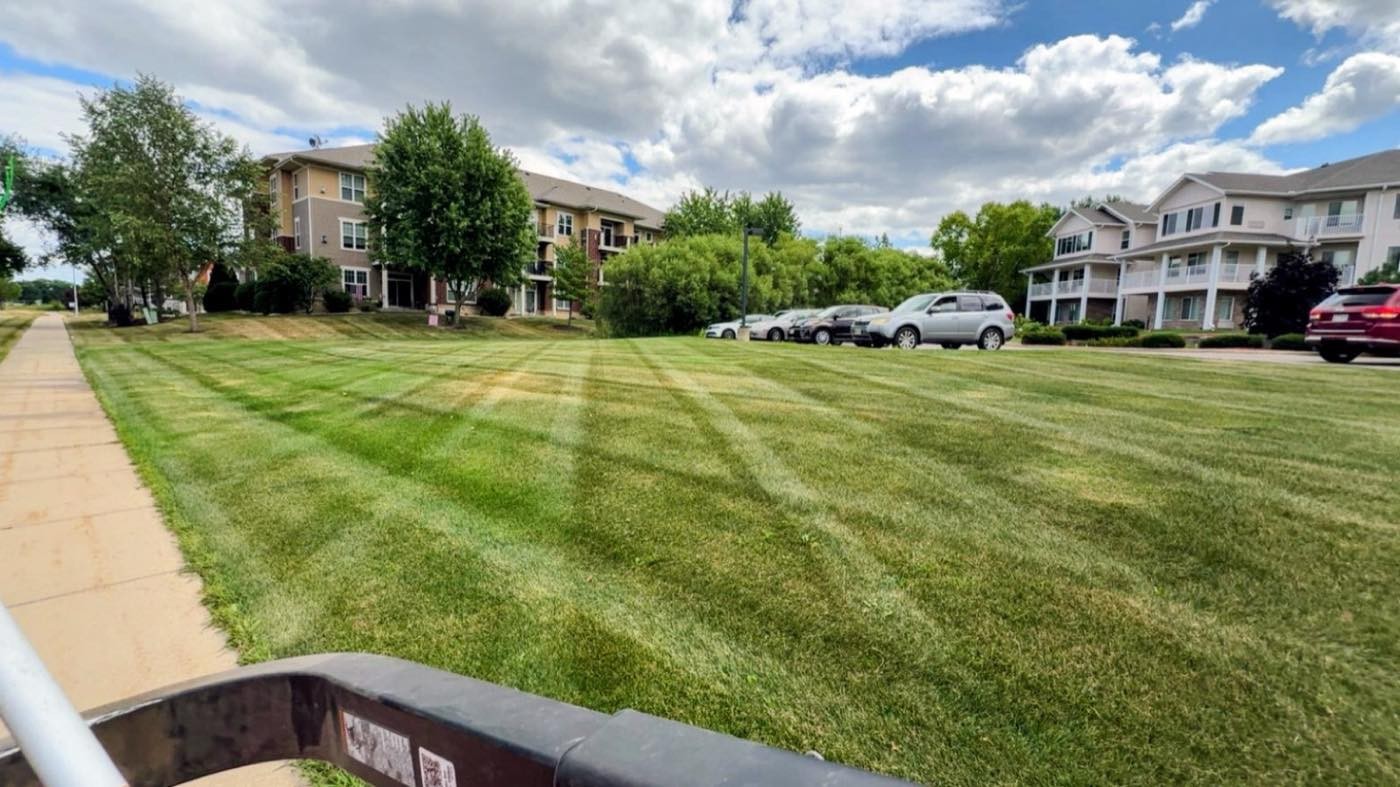 Wide striped lawn in front of a condo development