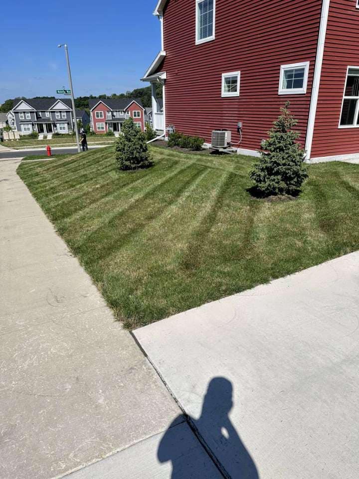 Striped lawn beside a red house