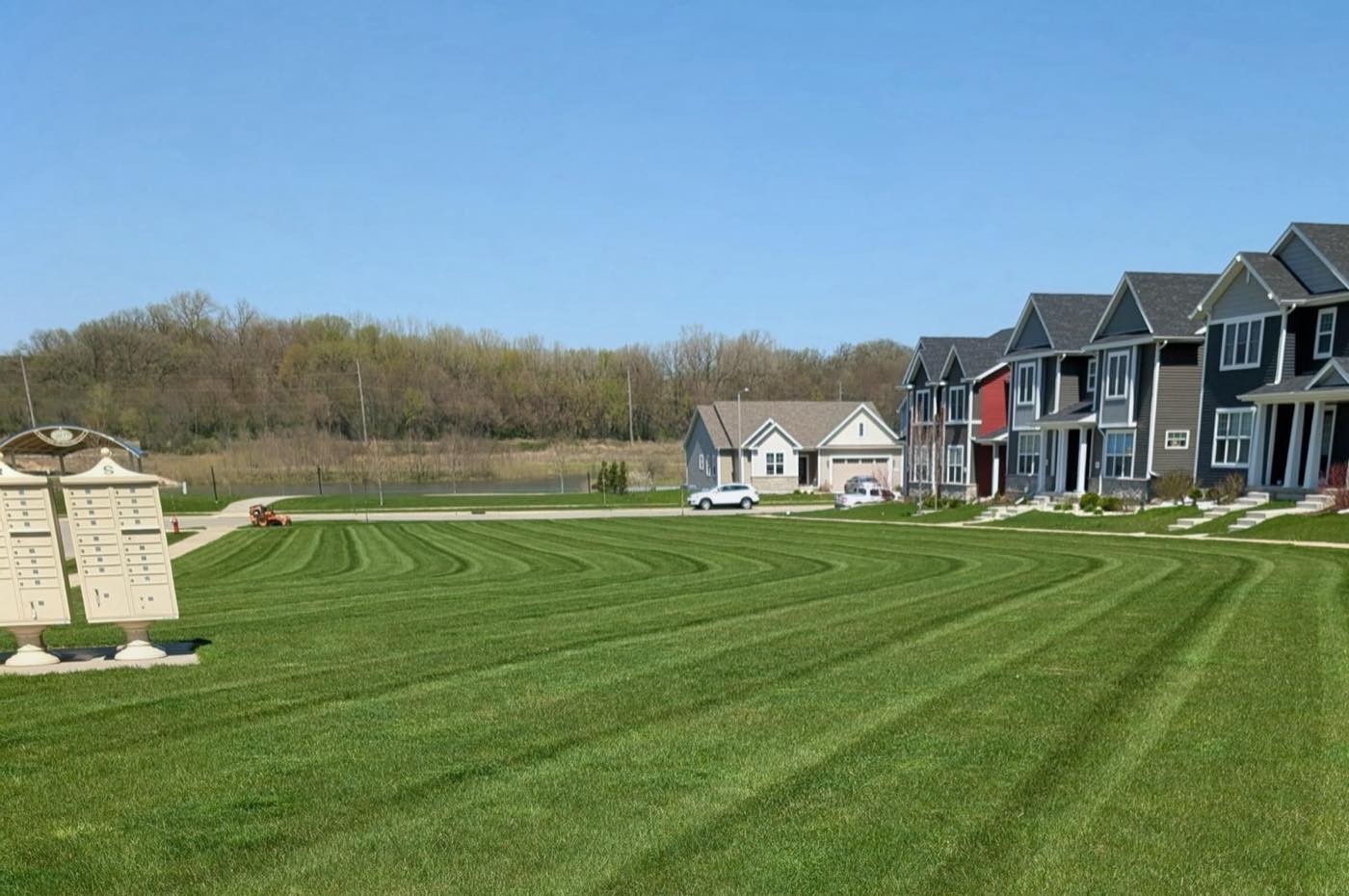Wide striped lawn in front of a row of townhomes